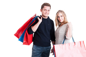 Attractive couple holding bunch of shopping bags