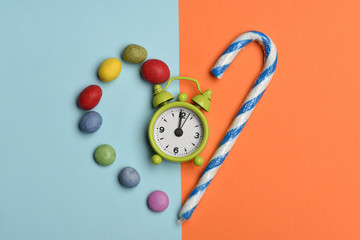 Green alarm clock with colorful dragee