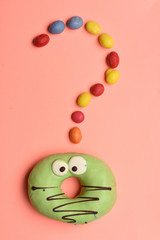Funny surprised donut with colorful dragee