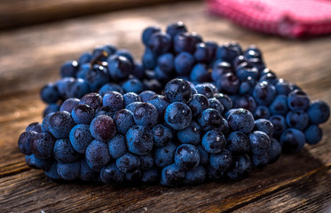 Organic  red grapes on  old wooden table.