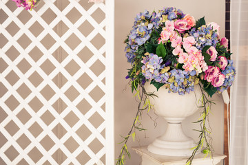 Beautiful flowers and vase in interior
