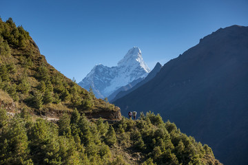 unidentified nepalese people on the way to Everest base camp. 2016. The way from Namche Bazar to Tengboche village with Ama Dablam peak behide.