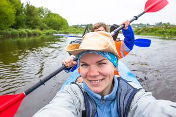 Kayaking on beautiful nature at summer sunny day. Sport people having fun