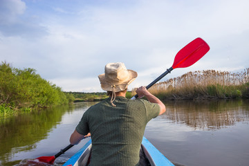 Kayaking on beautiful nature at summer sunny day. Sport people having fun