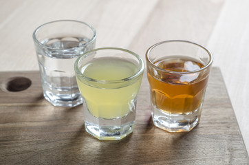 Glass of alcohol on wooden background