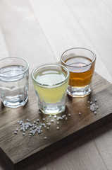 Glass of alcohol on wooden background