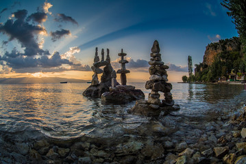 Stone sculptures at sunset by the Ohrid lake - obrazy, fototapety, plakaty