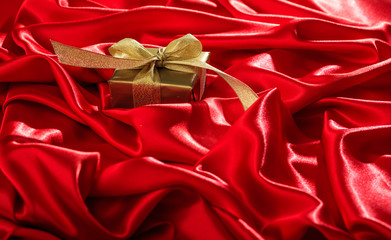 Gift box on a red satin background