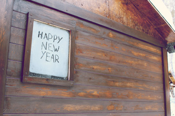 The inscription "Happy New Year" on the frosty window
