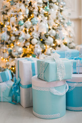 Christmas gifts under the decorated tree in blue