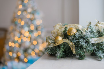 Gold and blue Christmas background of de-focused lights with decorated tree