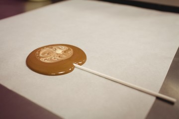 Close-up of lollipop drying on wax paper