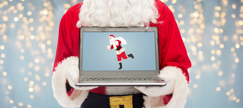 close up of santa claus with laptop