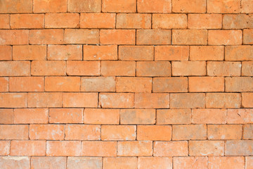 the old and dirty orange brick wall in warm or hot color tone/style with black stain for background texture