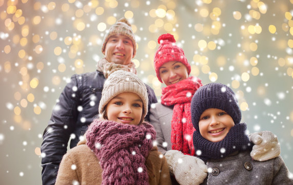 Happy Family Over Christmas Lights And Snow