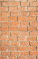 the old and dirty orange brick wall in warm or hot color tone/style with black stain for background texture