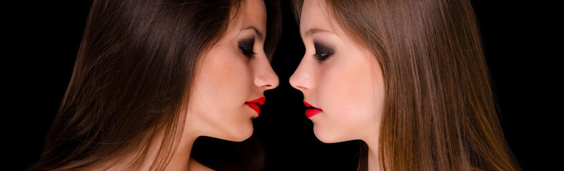 Profiles of two beautiful girls being intimate