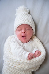 newborn making a funny face wants to sleep
