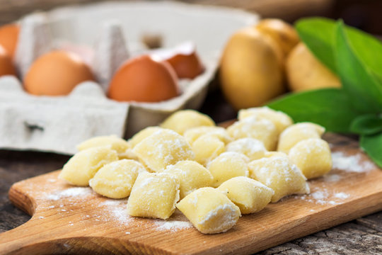 Uncooked homemade gnocchi on  cutting board