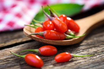 Fresh goji berries on wooden background