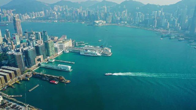 Hong Kong aerial view with urban skyscrapers boat and sea, zoom timelapse, 4k
