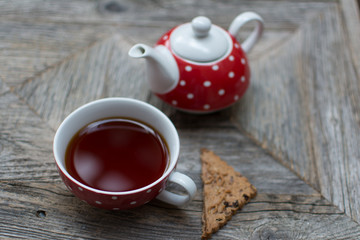 Rooibos Tea In Cup With Teapot And Cookie