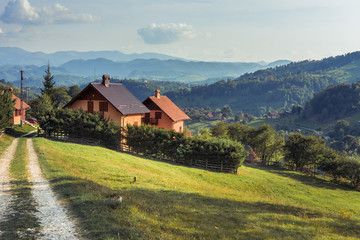 Fototapeta na wymiar Landscape of Magura village houses and hills with the Carpathian mountains in backgroumd