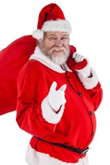 Portrait of santa claus holding christmas bag and gesturing