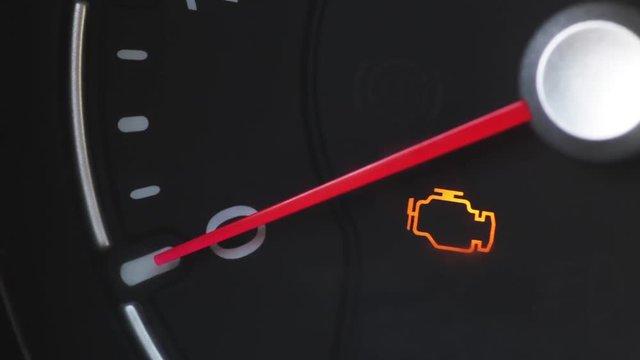 Color footage with various icons lighting up on a car's dashboard.