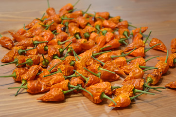 lot of small dried chilli lying on the wood table detail photography