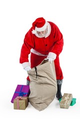 Santa claus filling gift boxes in the sack