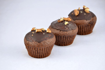 three chocolate brown muffins in the line dessert