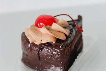 piece of chocolate cake and cherry