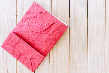 Paper shopping bag on the wooden background