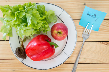 Note paper with message and healthy vegetables on wooden backgro