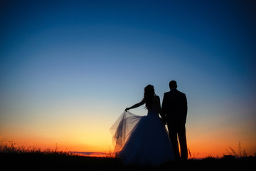 Fototapeta na wymiar Couple in love silhouette during sunset
