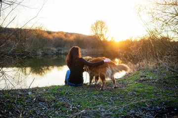 Girl playing with Caucasian shepherd dog, autumn