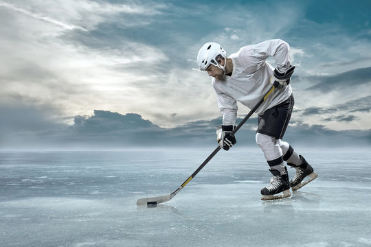 Ice hockey player on the ice in mountains