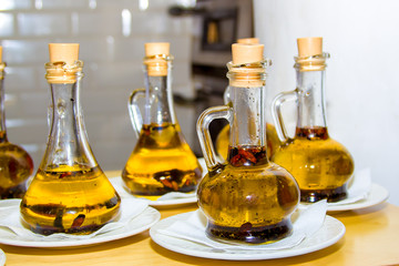 several receptacles with olive oil with spices for pizza