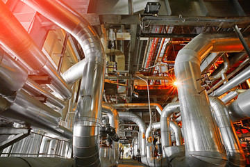 Equipment, cables and piping as found inside of a modern industr