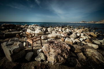 Chair on beach rocks