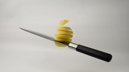 Japanese knife cuts potatoes, flying in the air
