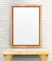 Blank wooden photo frame hanging at white brick wall on wood tab