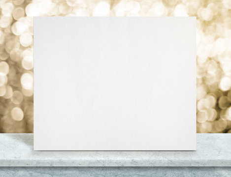 Blank white paper poster on blue marble table top and sparkling