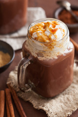 hot chocolate with whipped cream caramel in mason jar