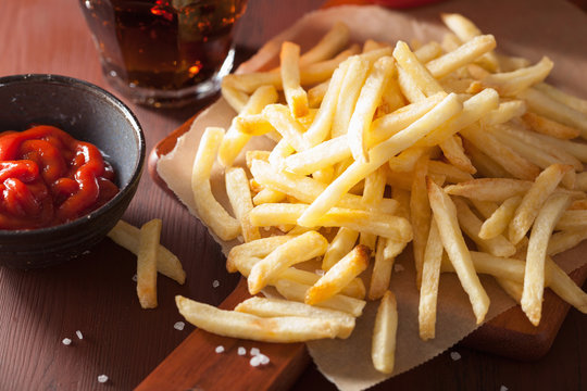 french fries with ketchup over rustic background