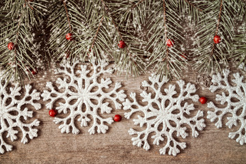 Fir branch and silver shiny snowflakes
