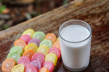 Glass of milk and colorful candy