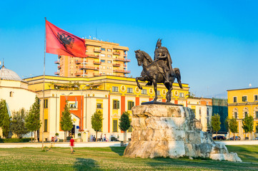 Skanderbeg square with flag, Skanderbeg monument and The Et'hem Bey Mosque in the center of Tirana...