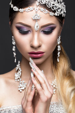 Beautiful girl in the image of the Arab bride with expensive jewelry, oriental make-up and bridal manicure. The beauty of the face. Photos shot in the studio.